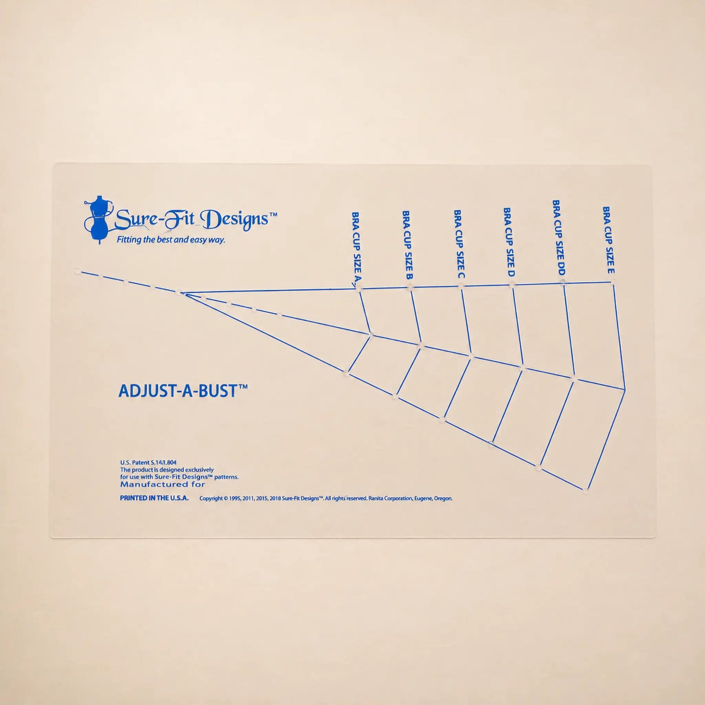 A Sure-Fit Designs Adjust-A-Bust paper sizing chart with blue printed lines and text on a light beige background.