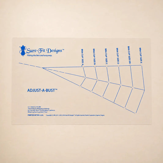 A Sure-Fit Designs Adjust-A-Bust paper sizing chart with blue printed lines and text on a light beige background.