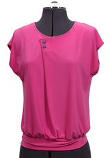 Pink blouse on a mannequin against a plain background