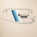 A clear plastic quilting ruler with blue and white striped center design, featuring the Sure Fit Designs logo and brand website, displayed on a light beige background.