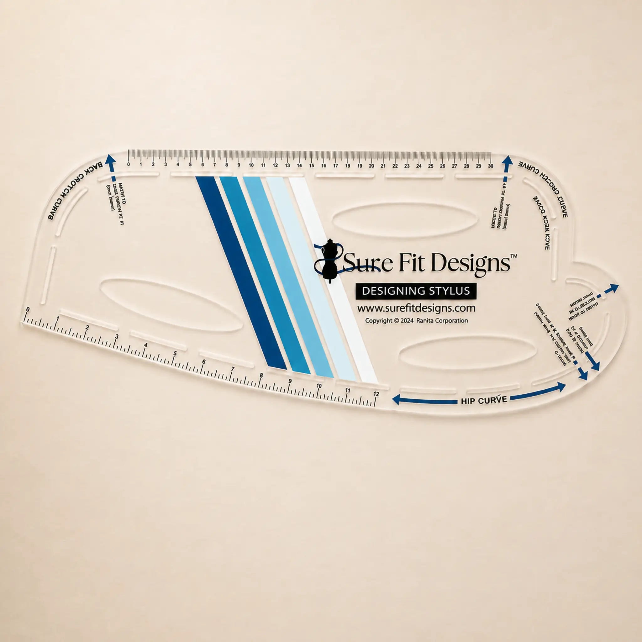 A clear plastic quilting ruler with blue and white striped center design, featuring the Sure Fit Designs logo and brand website, displayed on a light beige background.