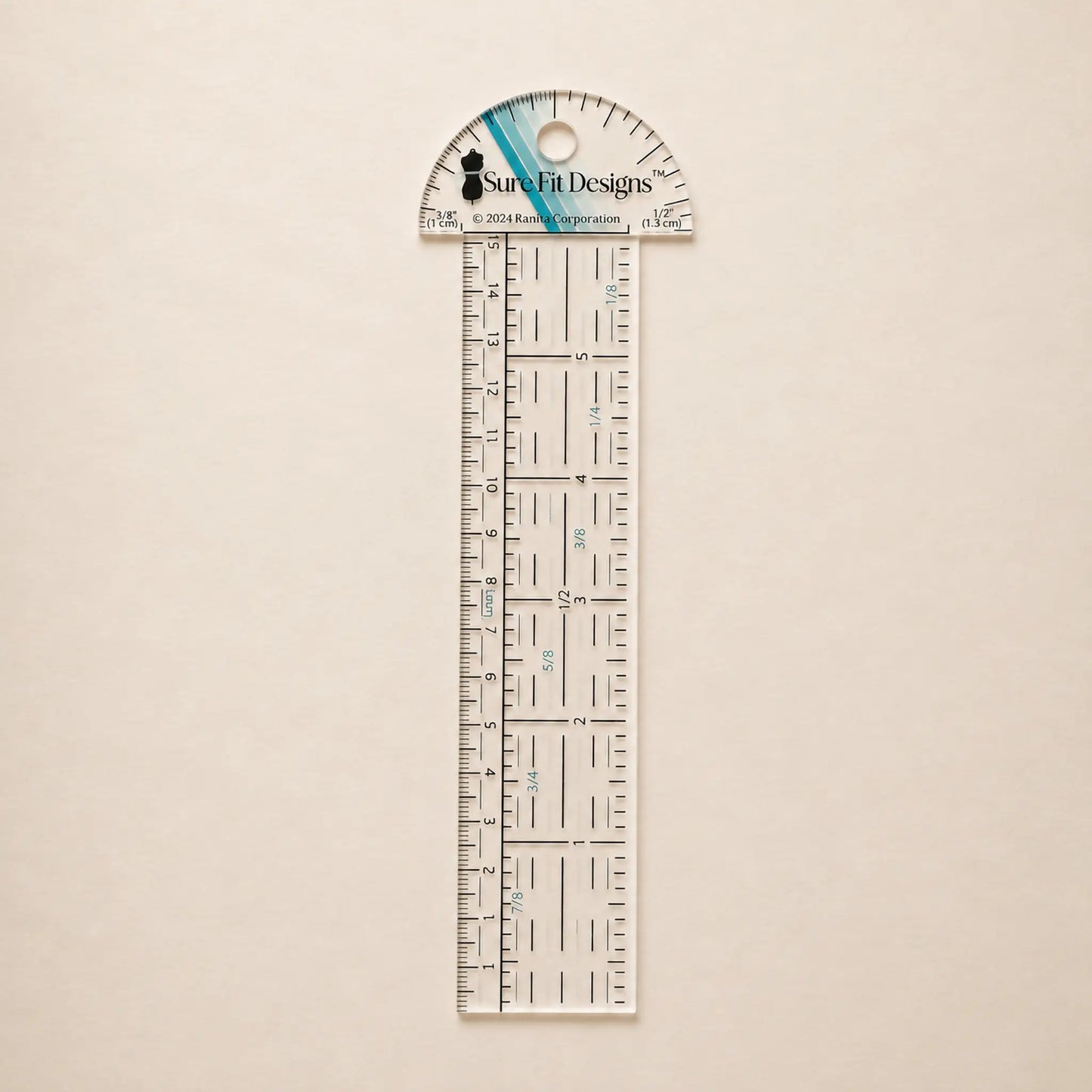 A clear acrylic ruler and protractor set by Sure Fit Designs, featuring black measurement markings and a blue accent stripe on the protractor cap, displayed on a light beige textured background.