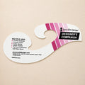 A Sure-Fit Designs Designer's Companion curved cardboard hanger insert on a light beige background, featuring pink and white diagonal stripes and black text.
