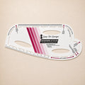 A Sure-Fit Designs Designing Stylus measuring tool for hair extensions, shown on a light beige background. The white plastic tool features magenta and pink gradient stripes, black text, and measurement markings.