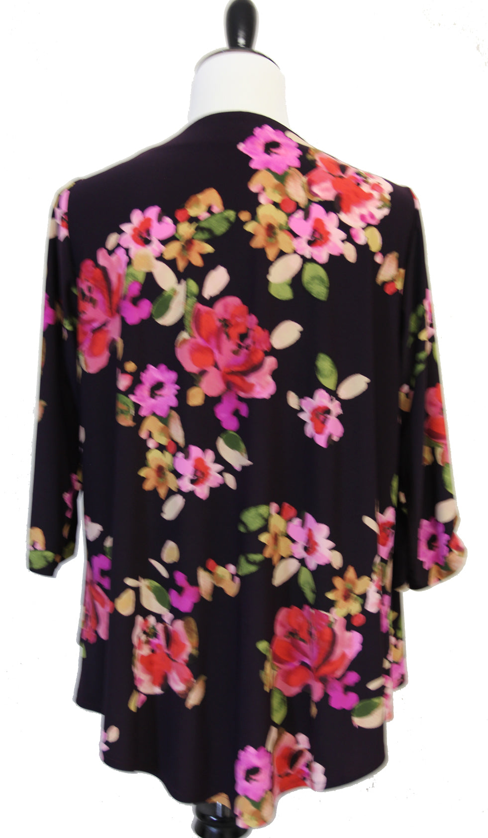 Black cardigan with colorful floral pattern on a mannequin against a white background