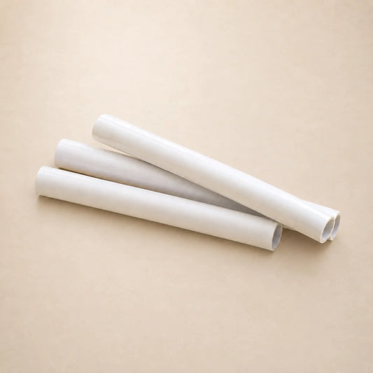 Three rolls of transparent vellum arranged diagonally on a plain beige background.