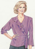 Woman wearing a purple blouse with ruffled details