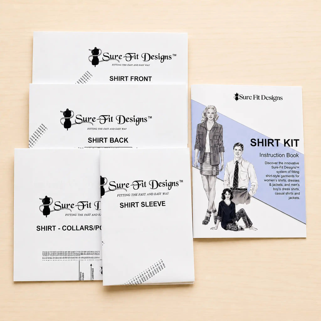 A set of white Sure Fit Designs shirt kit instruction sheets and packaging laid out on a light wood background, including front and back views and an instruction book.
