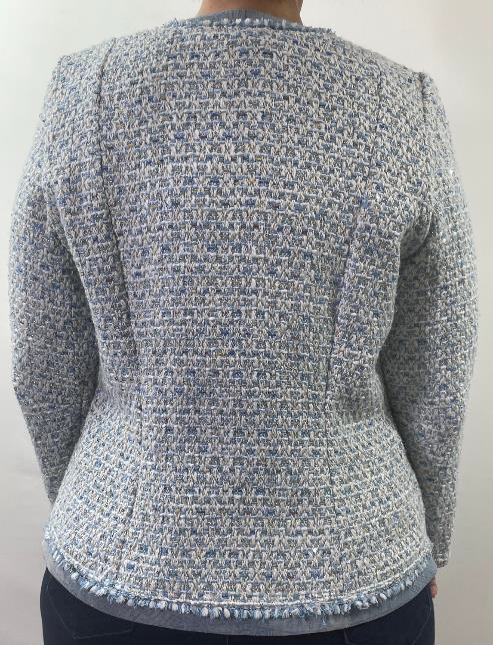 Back view of a textured gray sweater on a plain background