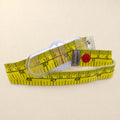 A yellow measuring tape with black printed numbers and markings, a clear plastic dial window, a red tension knob, and a silver metal brand plate reading 'PochetteFrancaise'.