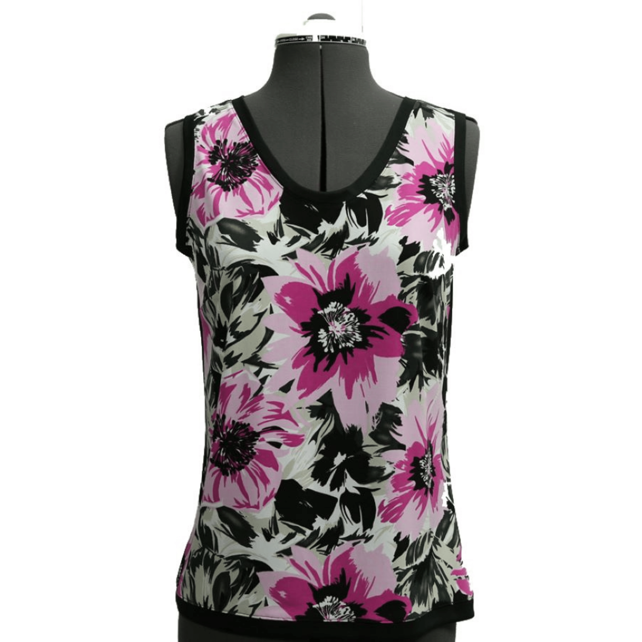 Floral tank top with pink and black flowers on a mannequin against a green background
